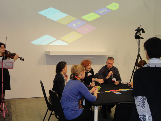 London-based artist Liliane Lijn performs her Poem Game with visitors to ART14 London last week. Image Auction Central News.  